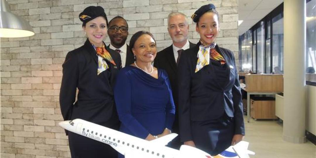 Fly Blue Crane Launch 2015. Jerome Simelane (second from left), Siza Mzimela (third from left) and Theunis Potgieter (second from right), flanked by the airline’s lovely air stewardesses showing off their new uniforms. Photo by Debbie Badham. 