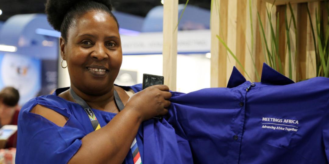 Caption: Judith Thobakgale, founder and manager of the Soweto Sewing Company holding one of the shirts the company produced for Meetings Africa this year.  Credit: Gauteng Tourism