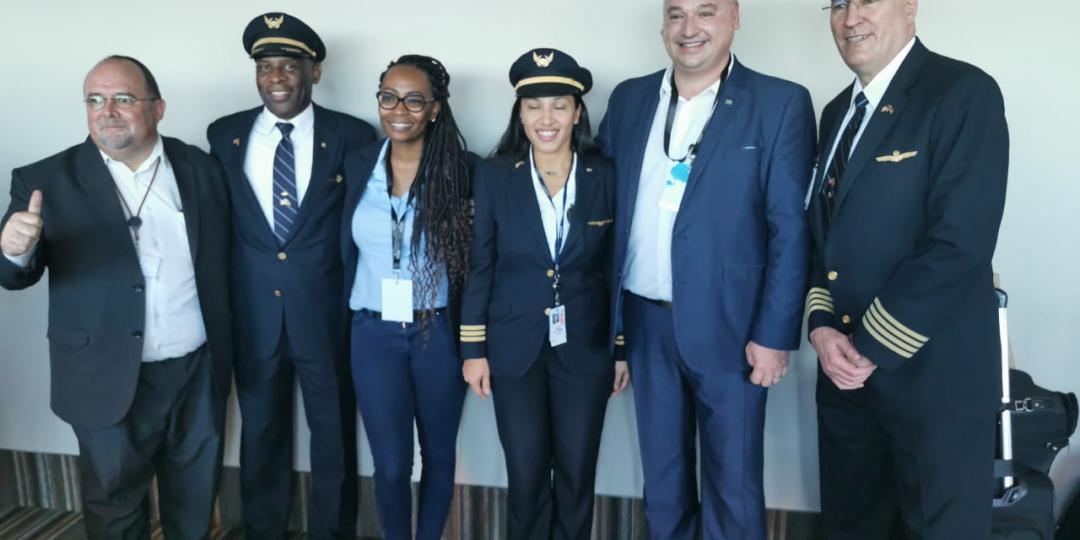 James Vos (second from right) poses with the crew of the new United Airlines flight to New York.