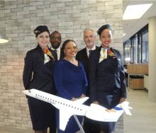 Fly Blue Crane Launch 2015. Jerome Simelane (second from left), Siza Mzimela (third from left) and Theunis Potgieter (second from right), flanked by the airline’s lovely air stewardesses showing off their new uniforms. Photo by Debbie Badham. 