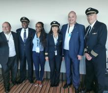 James Vos (second from right) poses with the crew of the new United Airlines flight to New York.